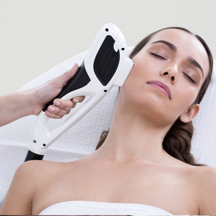 A woman getting her face cleaned by an esthetician.